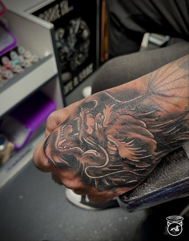 Japanese Dragon head on the back of the hand done at On the Road Tattoo