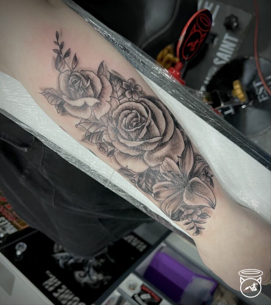 Rose and Lily tattoo done at the New Ramsey Tattoo Studio